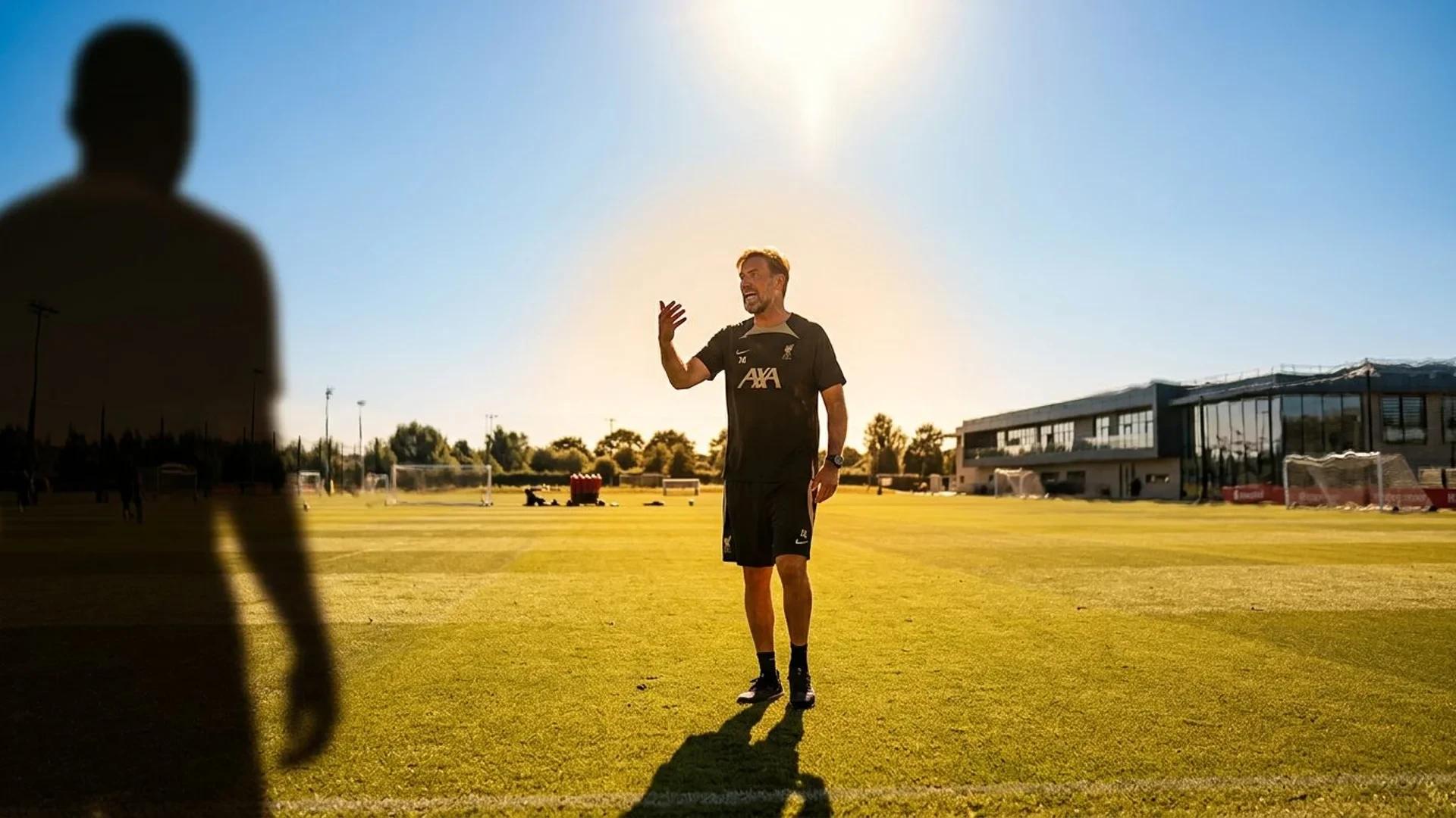 Jürgen Klopp animatedly discussing a transfer in bright sunlight at Liverpool's training ground.