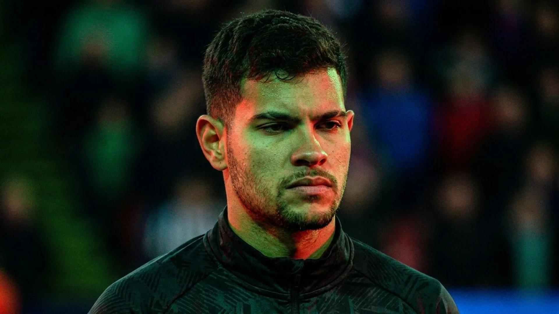 Close-up of Bruno Guimaraes with dramatic lighting and tension in his expression.