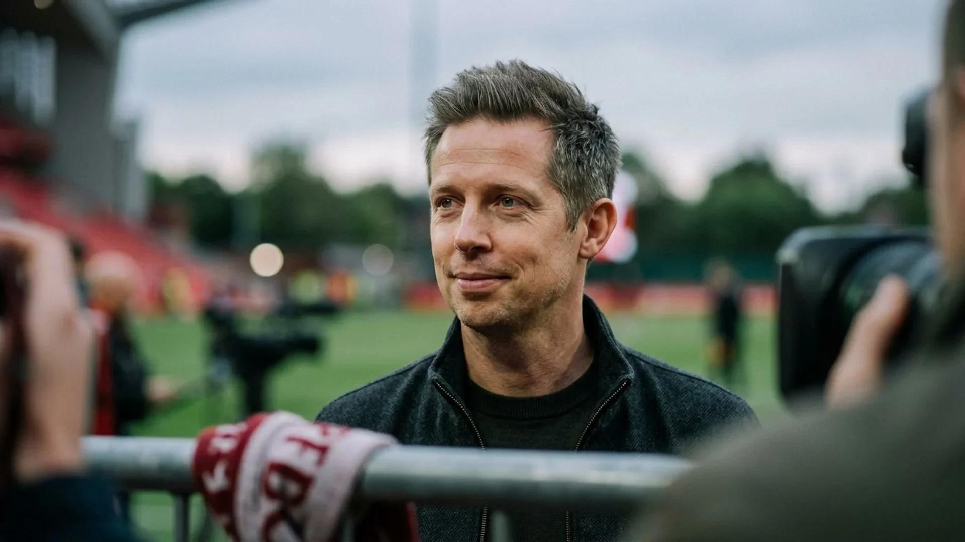Close-up of Michael Edwards with a reflective expression against a softly blurred background.