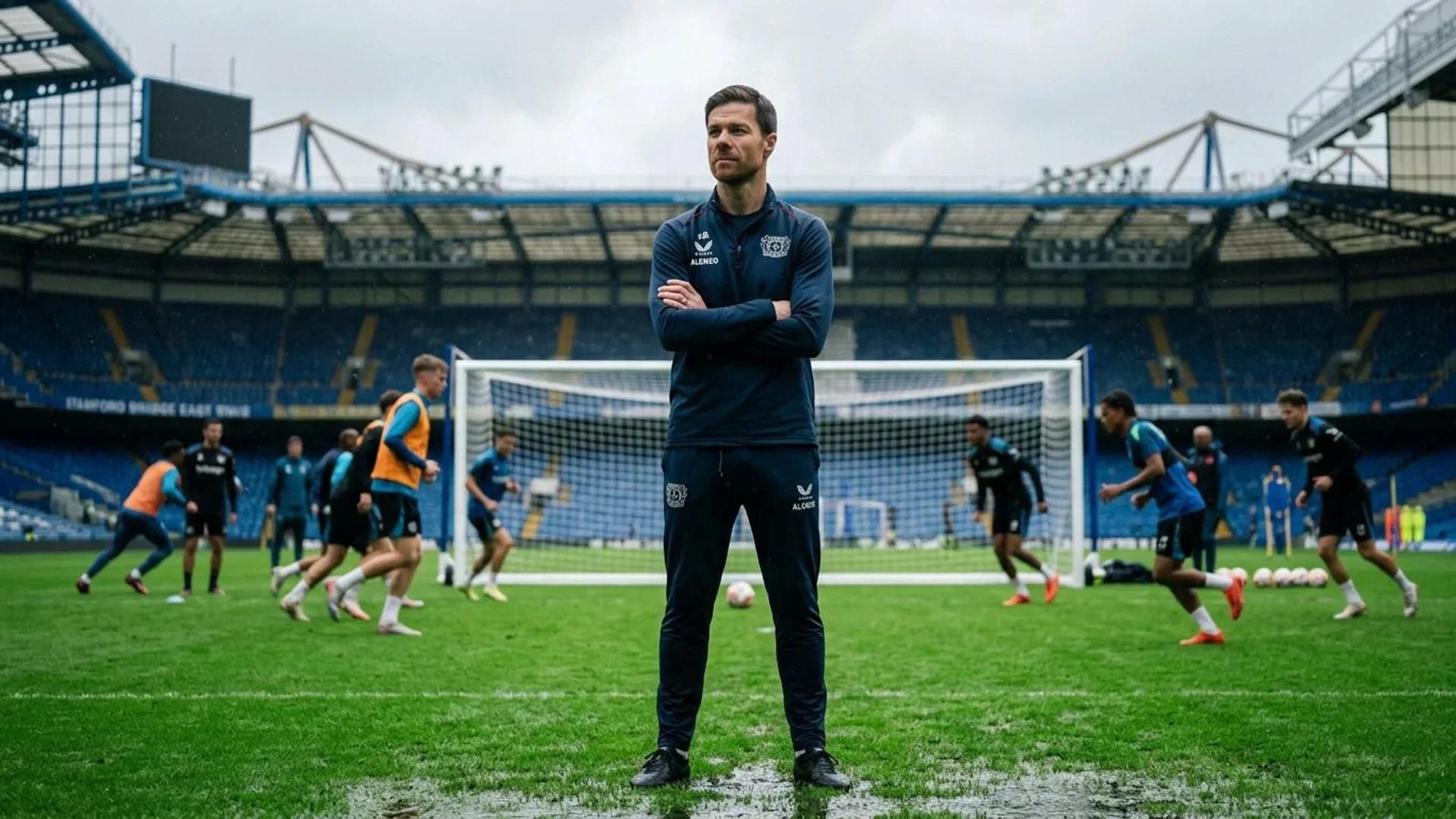 Xabi Alonso stands on a training pitch at Stamford Bridge, overseeing young players during practice.