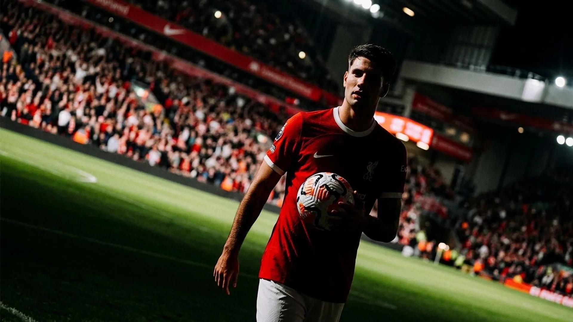 Dominik Szoboszlai on the pitch at Anfield, dramatically lit and captured at a Dutch angle.