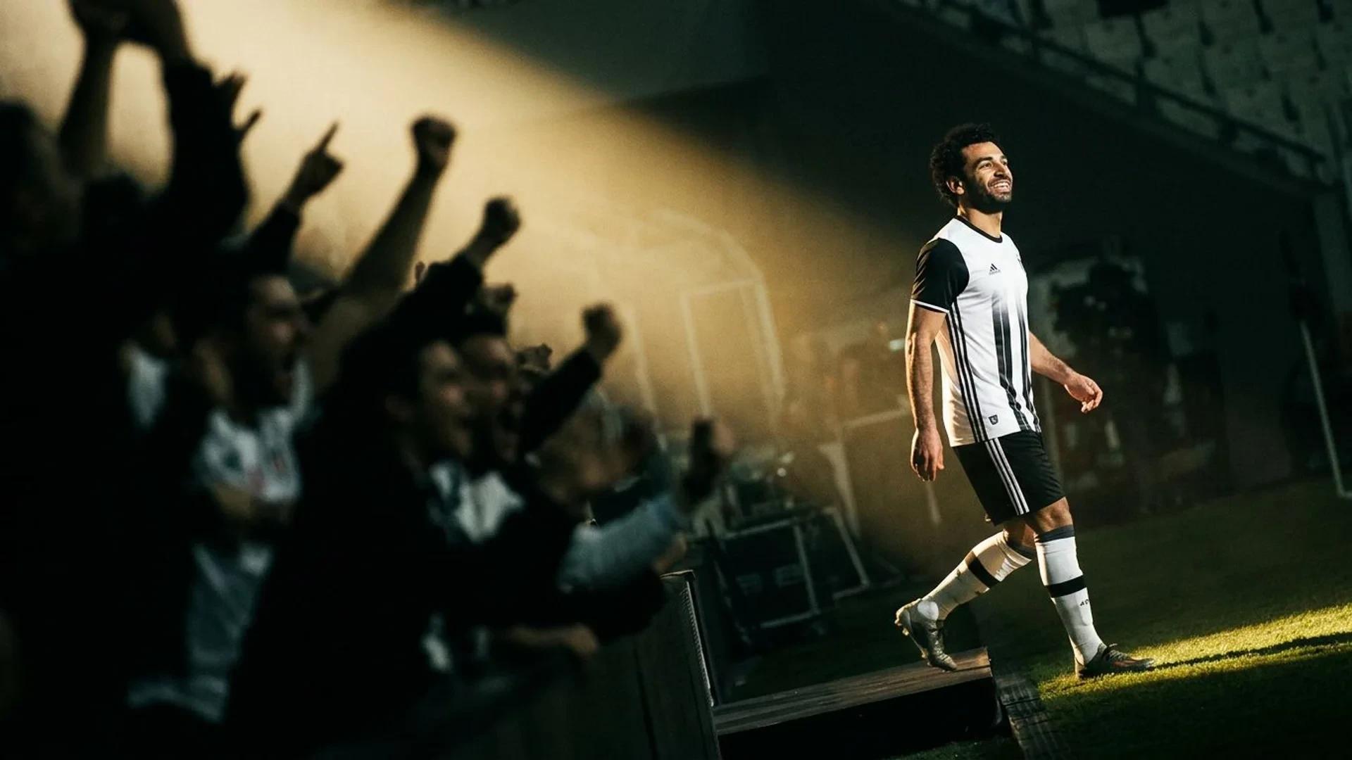 Mohamed Salah poses dramatically under a spotlight as he transitions to his new club Besiktas.