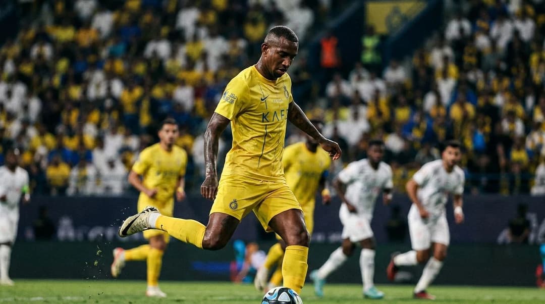 Close-up photograph of a football player executing a free kick.