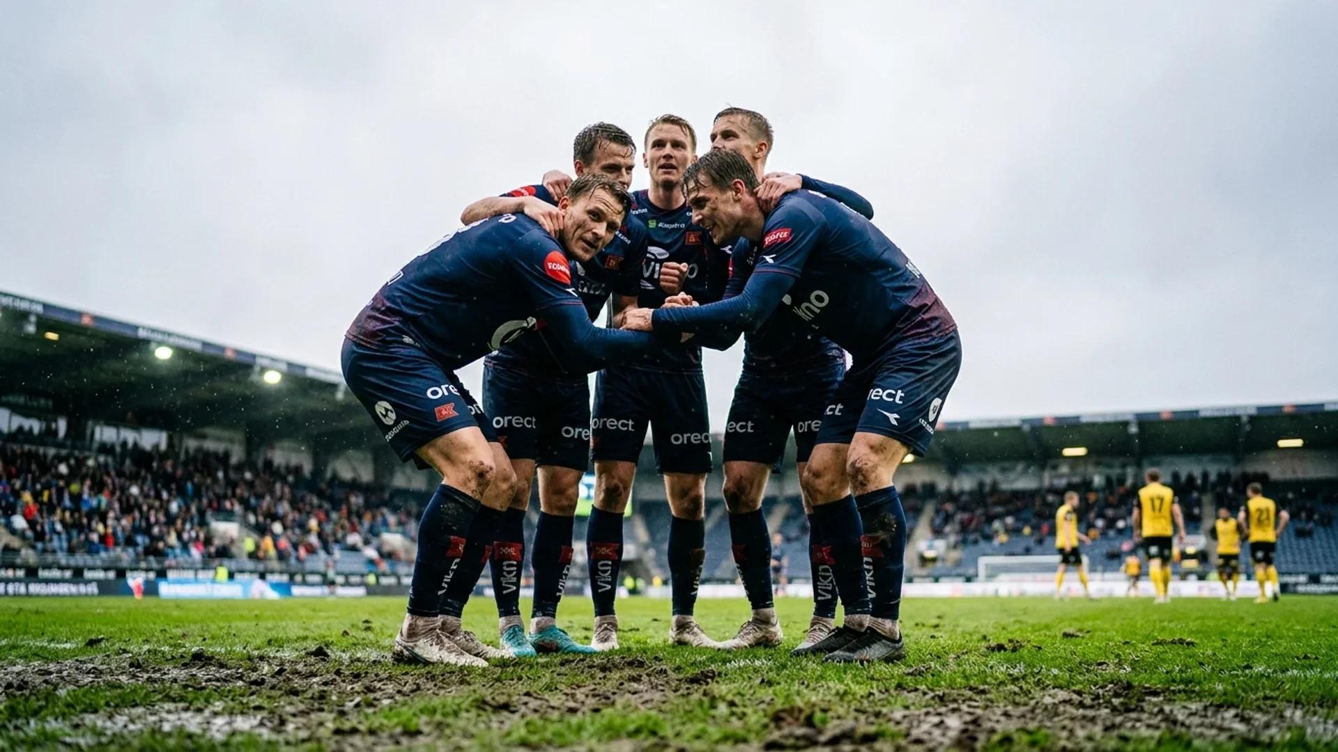 En gruppe Viking-spillere huddler sammen på fotballbanen med Åråsen stadion i bakgrunnen.