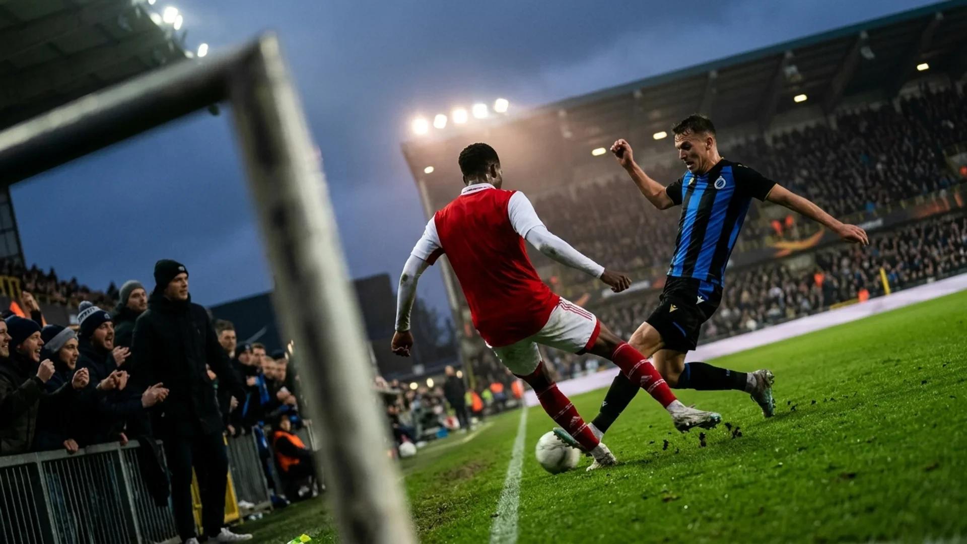 Football scene featuring players in a dynamic duel on a pitch during twilight.