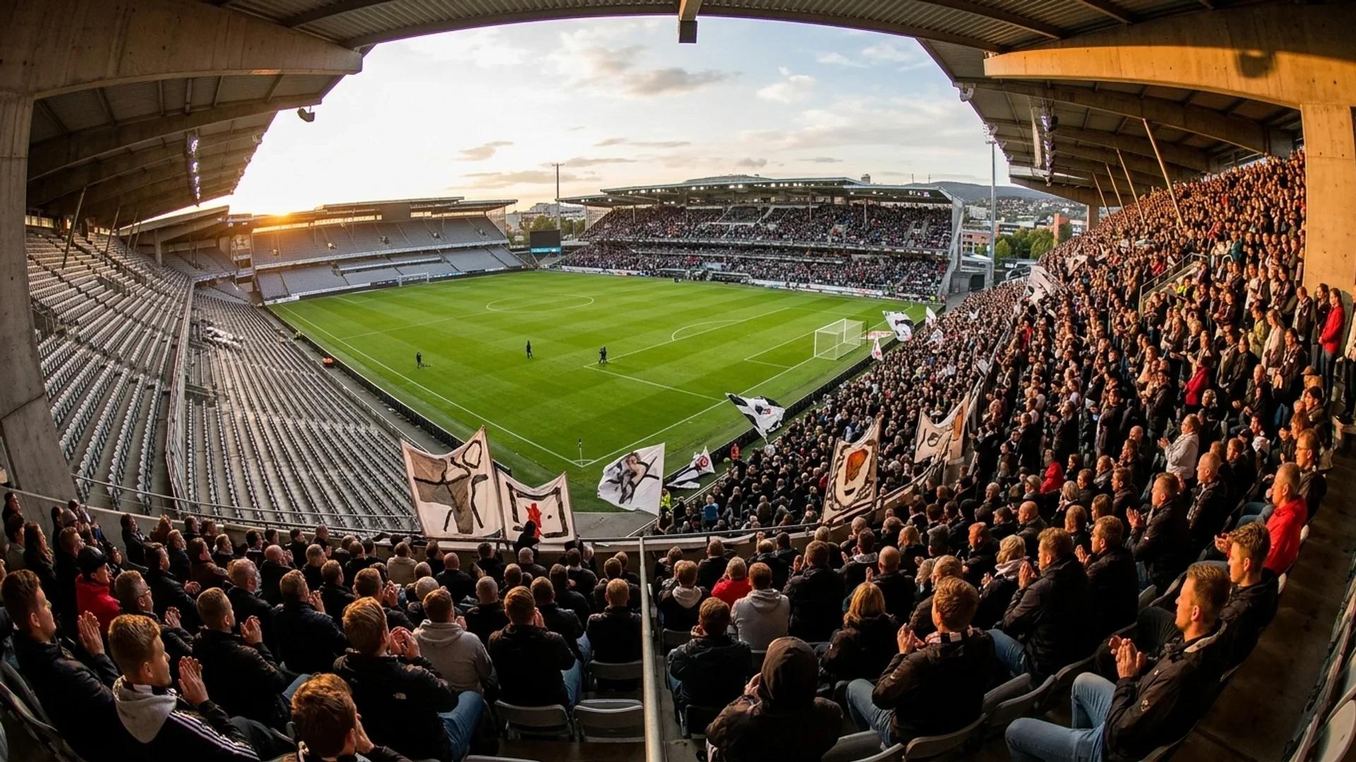 A wide shot of Lerkendal Stadium during a moment of silence before a football match, with fans sitting quietly.