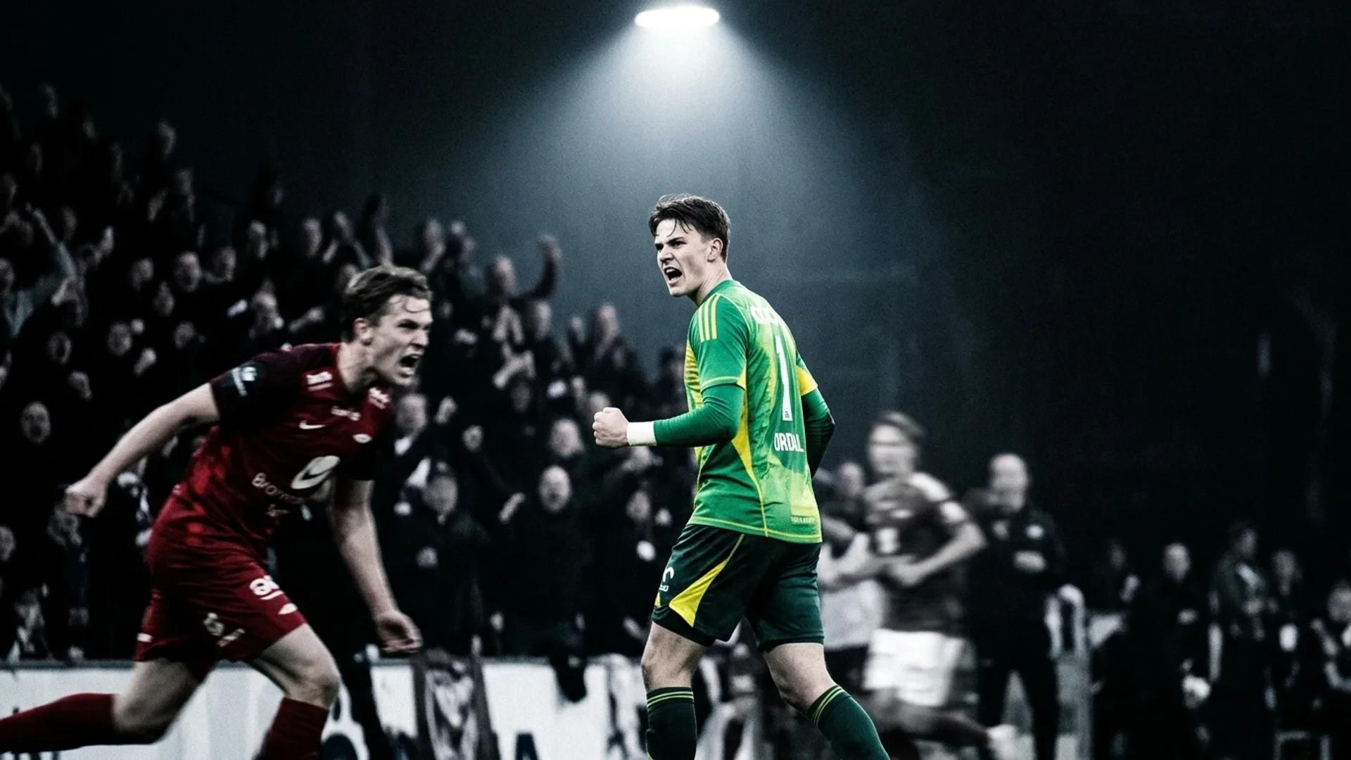En ung fotballkeeper midt i en intens feiring, omgitt av ustabile spillere og fans.