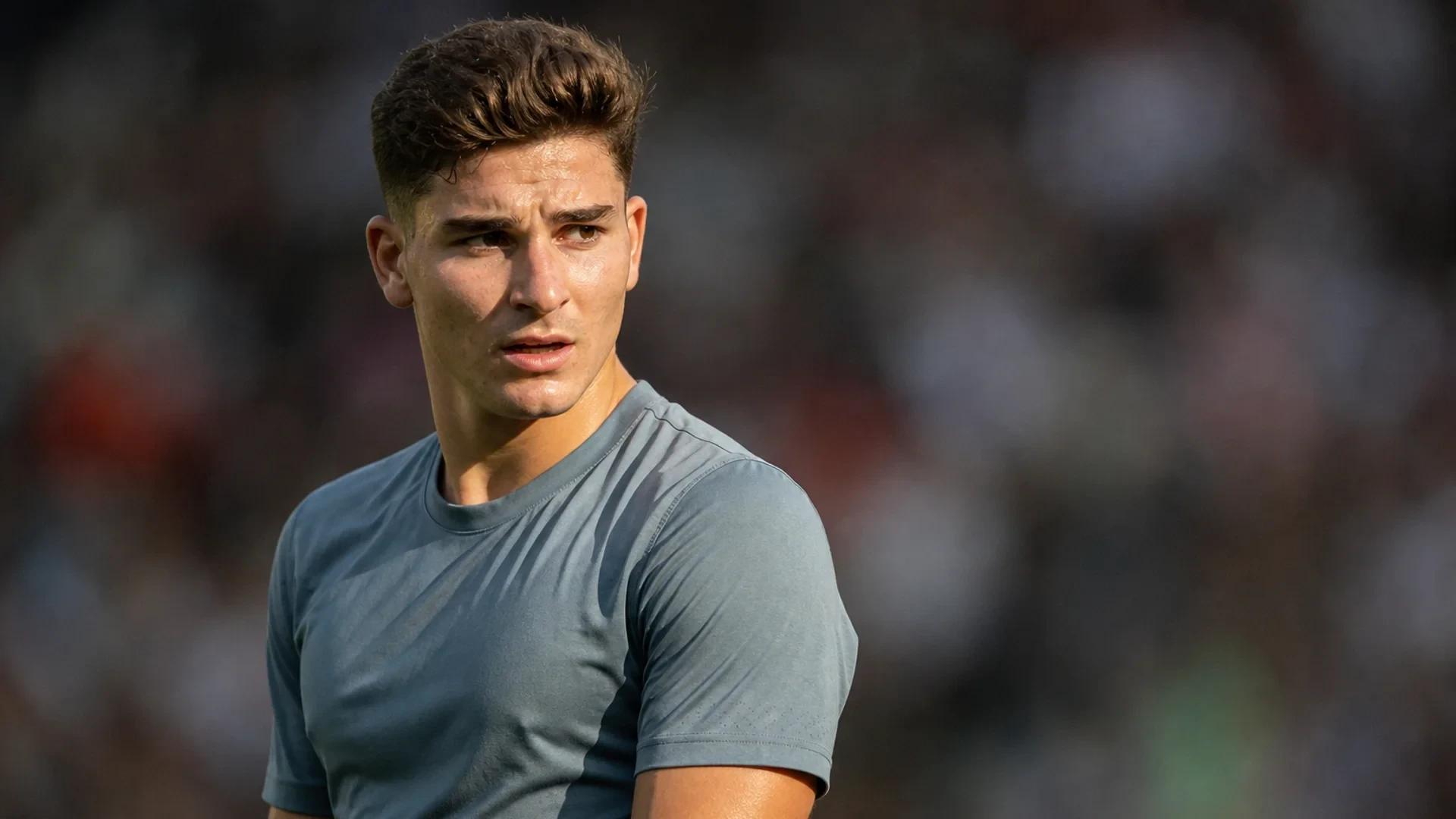 Julián Álvarez in unbranded athletic wear, captured in a medium shot with intense facial expression under harsh sunlight, with a softly blurred stadium background.