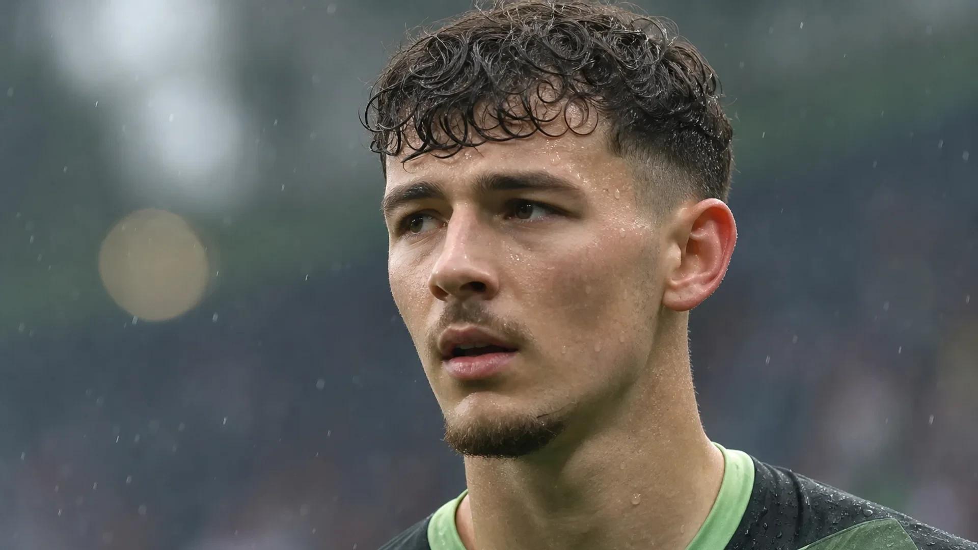 Close-up of goalkeeper James Trafford in a focused expression against a blurred stadium background.