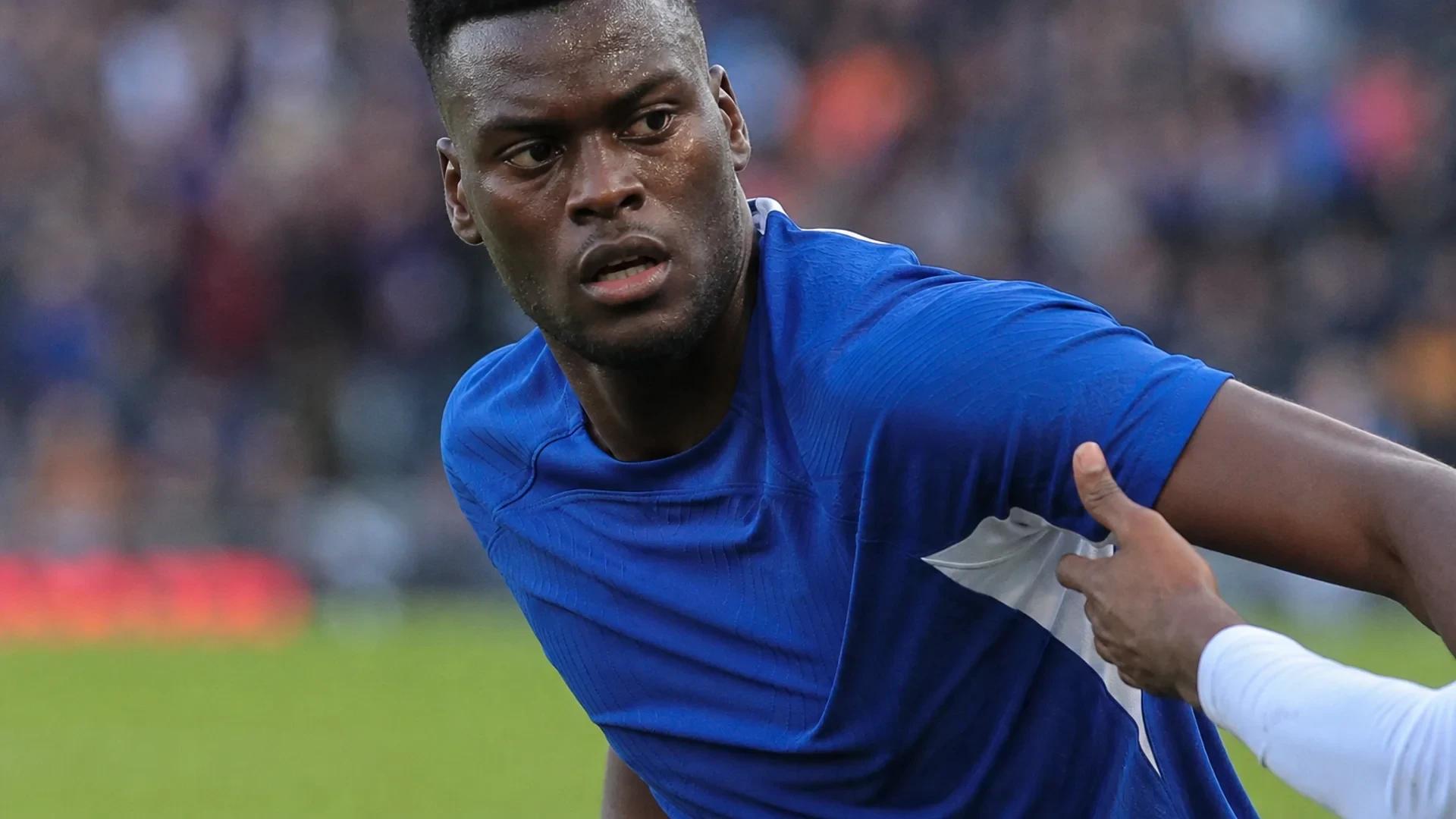 Benoit Badiashile in action on the soccer field during an intense moment of play.