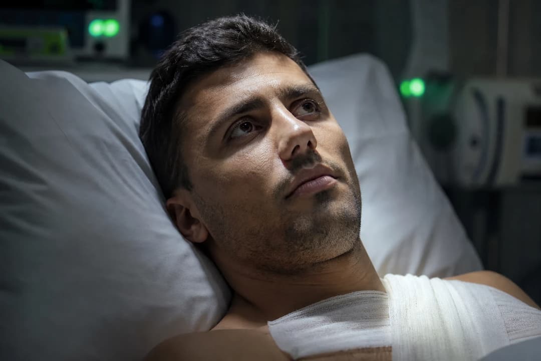 Close-up of Rodri resting in a recovery room, illuminated by soft daylight.