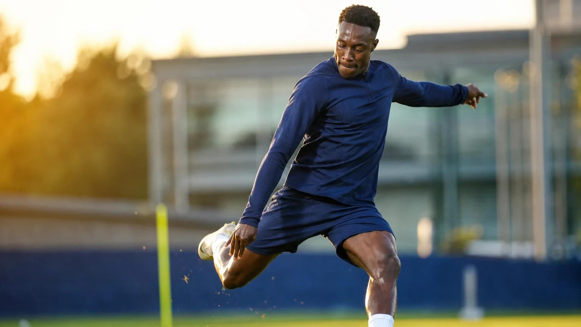Danny Welbeck striking a soccer ball during training at Chelsea's facility.