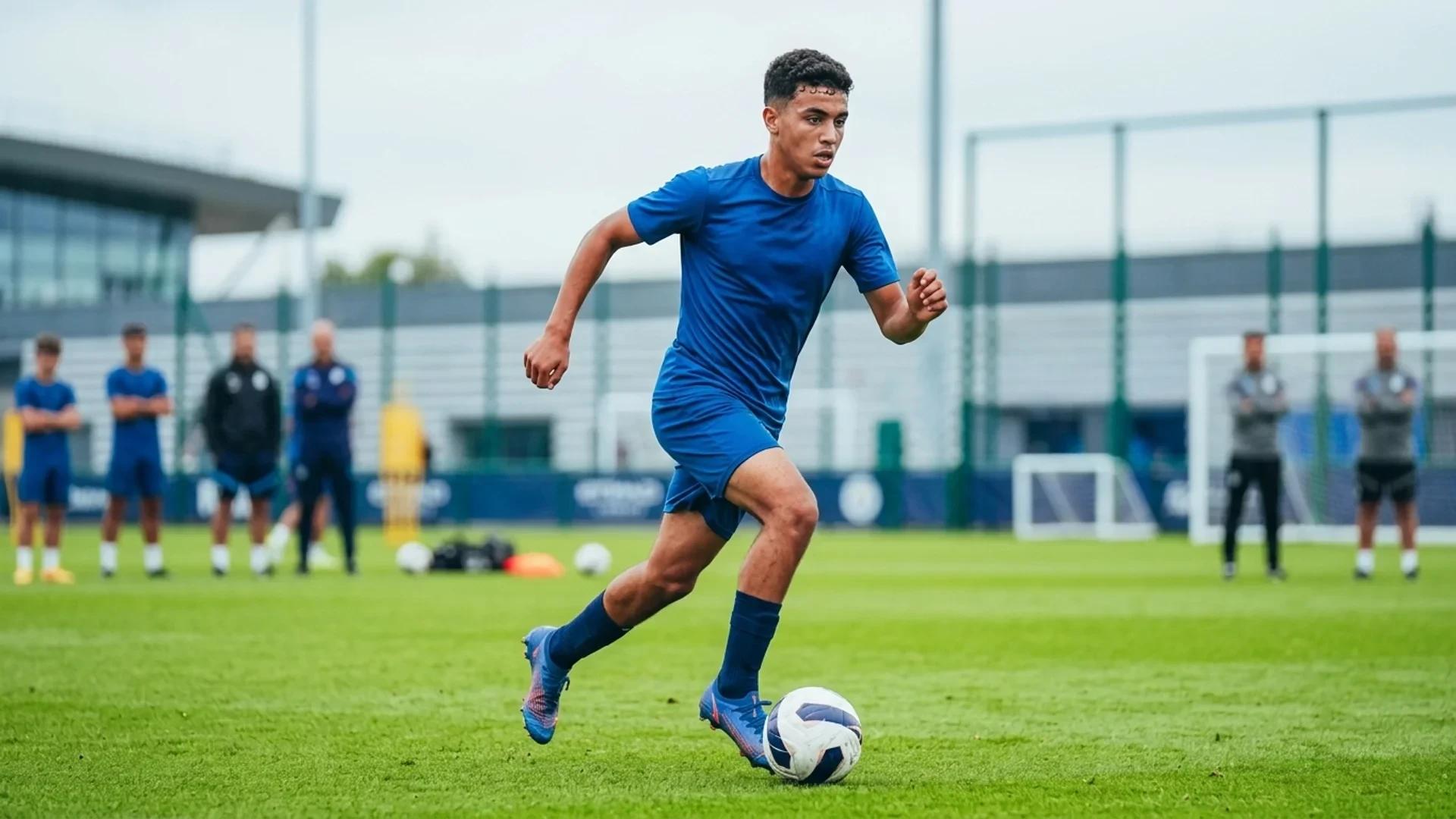 Ayyoub Bouaddi training intensely on the pitch with blurred background elements suggesting a soccer training facility.
