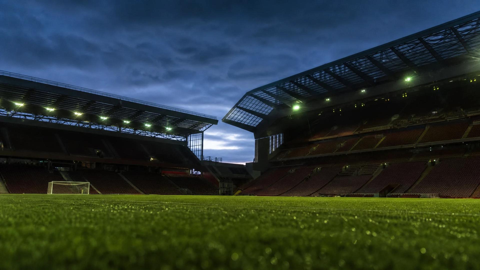 Anfield stadium at dusk, empty and tranquil.