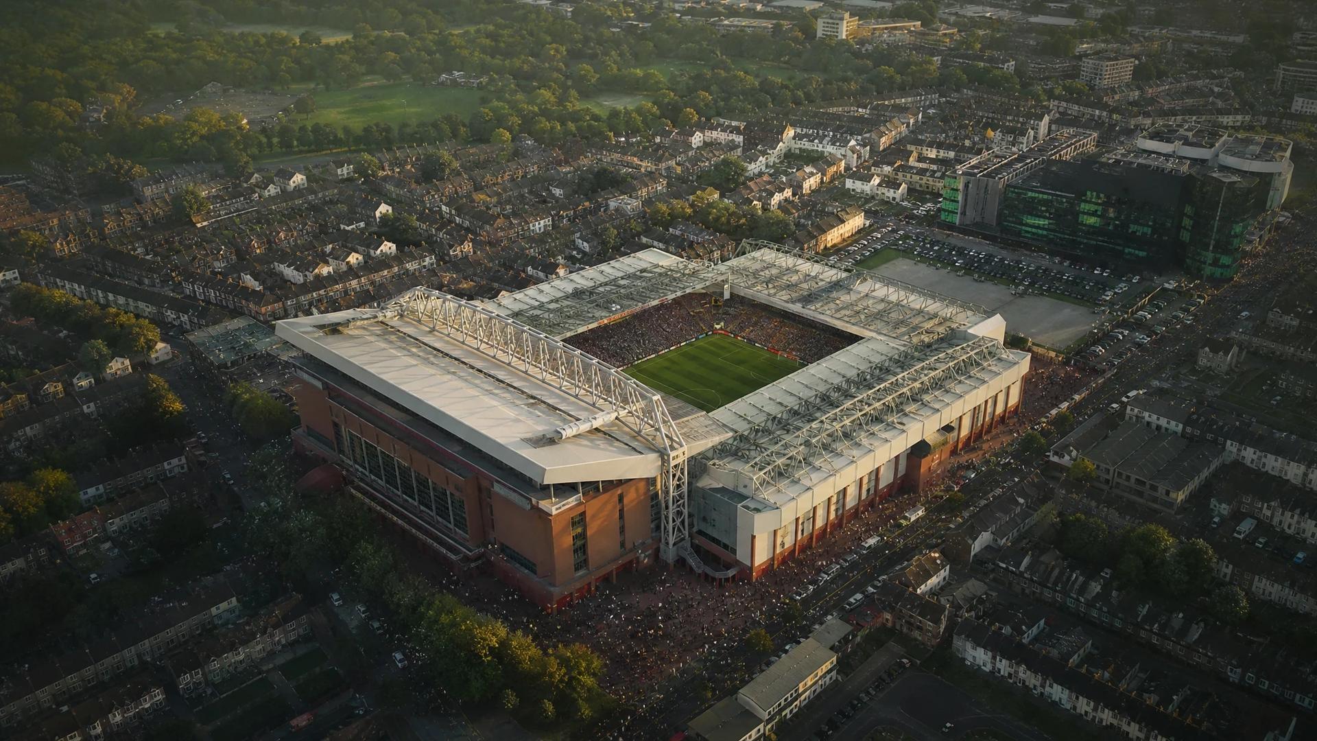 Aerial view of Anfield stadium surrounded by greenery and urban landscape.