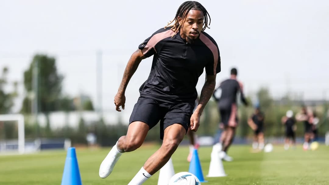 Bradley Barcola demonstrating dribbling skills during a football training session.
