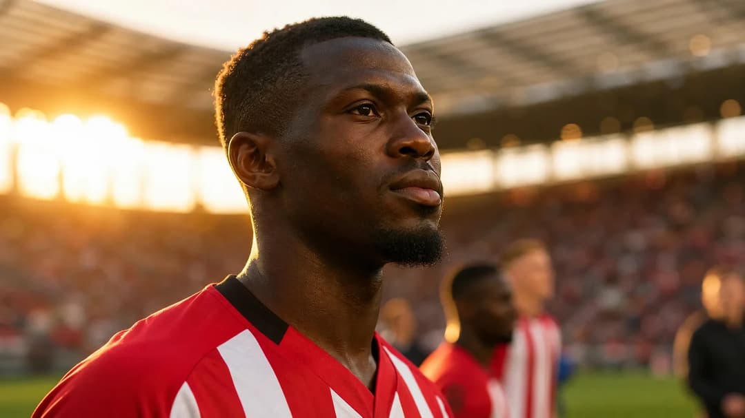 Mamadou Sangare stands on the football pitch, showcasing determination after signing with Brentford.