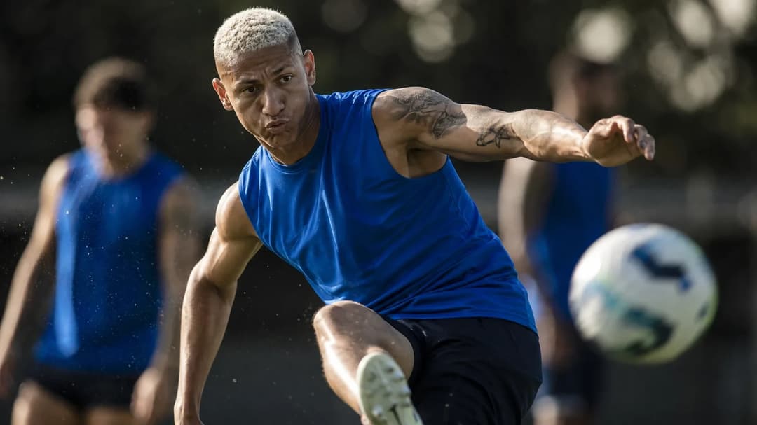 Richarlison striking a football during a training session, captured in motion.