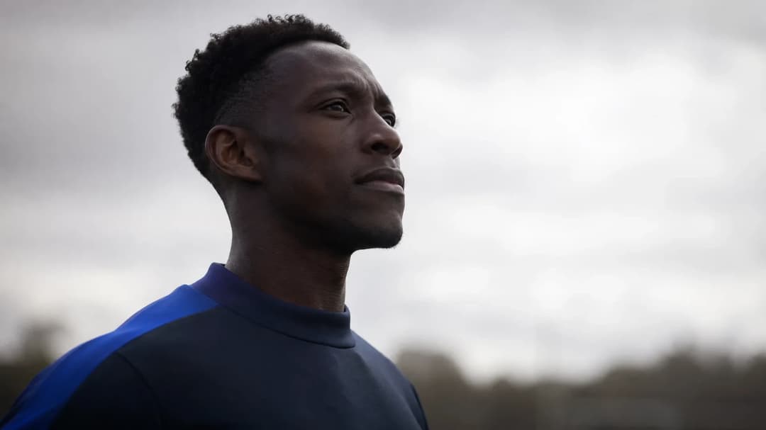 Danny Welbeck stands in silhouette against a soft bright background, reflecting on his transfer to Chelsea.