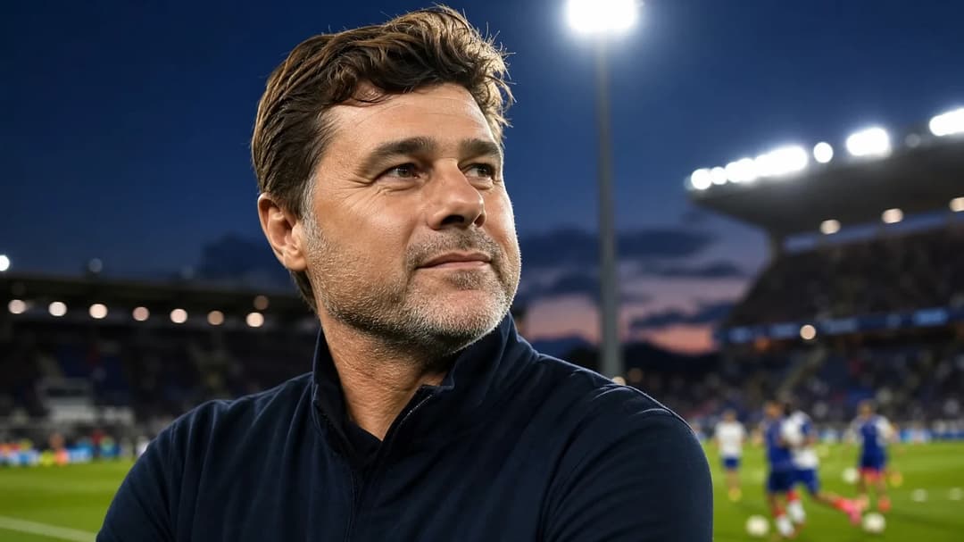 Mauricio Pochettino stands on the sidelines of a football pitch during a training session, looking determined.