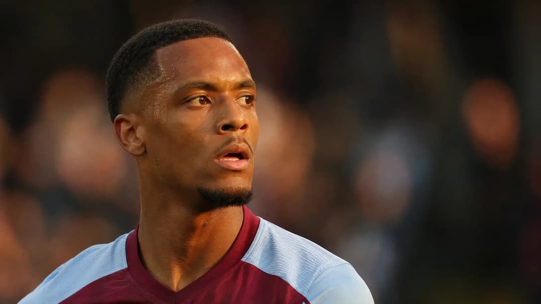 Ezri Konsa focused during a football match.