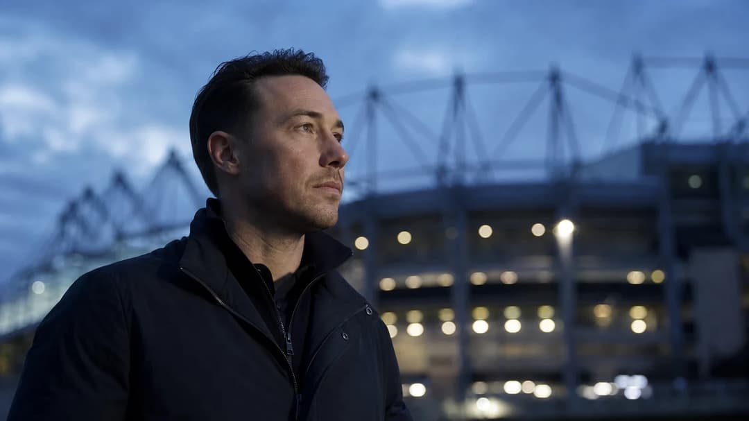 Matthias Jaissle stands silhouetted against St James' Park at dusk, reflecting quietly.