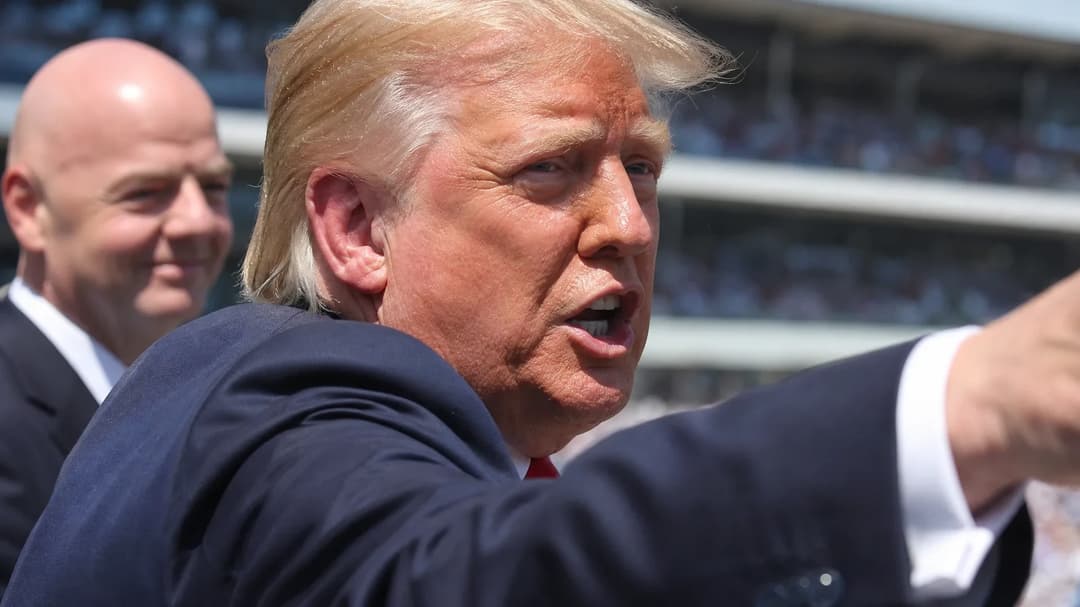 Donald Trump speaking passionately in a stadium setting.