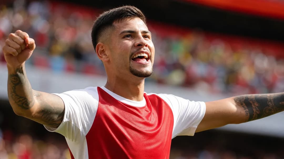 Bruno Guimarães celebrating a goal with joy in a blurred stadium background.
