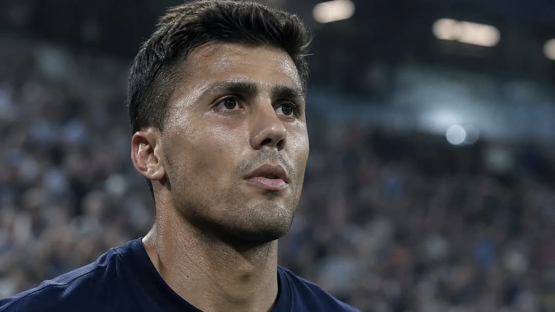 Rodri in a stadium during a match, focused and determined.