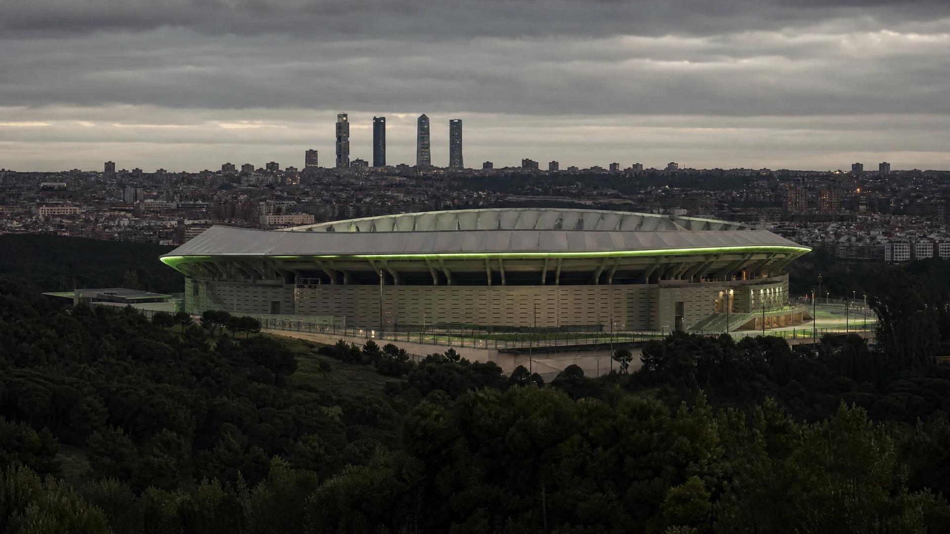 A wide shot of the Metropolitano Stadium in Madrid, shrouded in soft overcast lighting.
