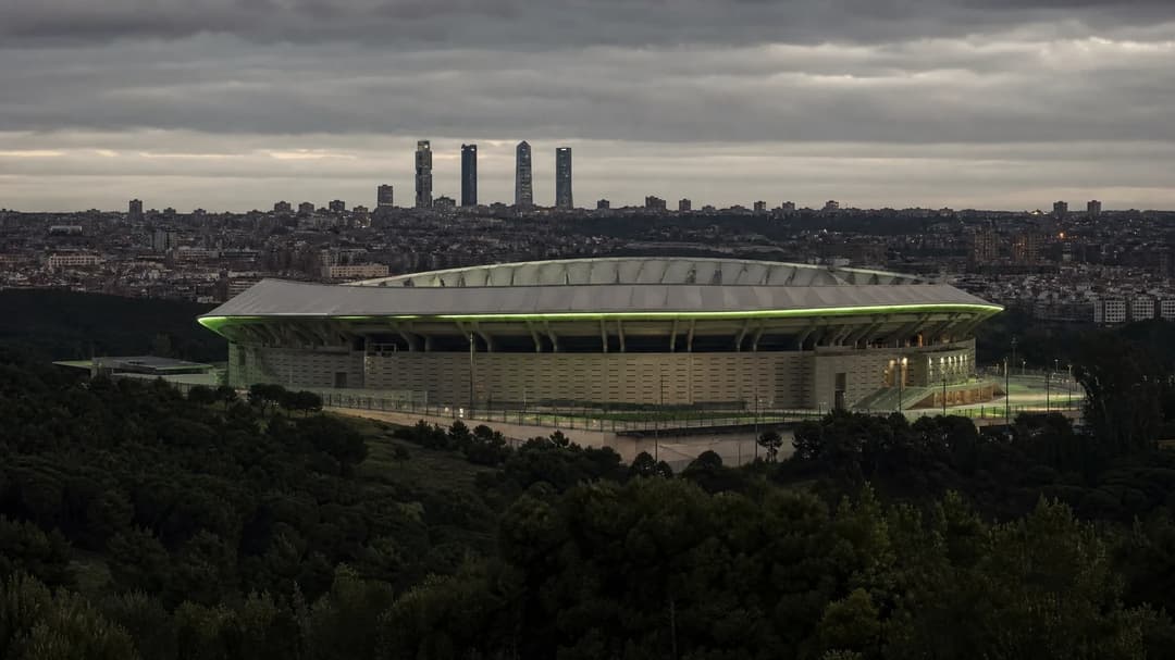 A wide shot of the Metropolitano Stadium in Madrid, shrouded in soft overcast lighting.