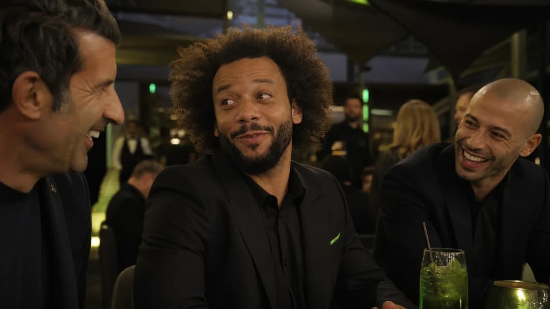 An over-the-shoulder view of Marcelo smiling and talking at the FC 27 launch event, with soft lighting and a cozy atmosphere.