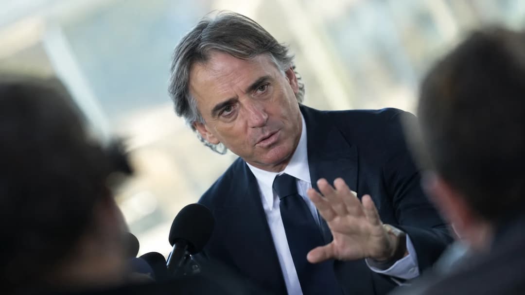 Roberto Mancini at a press conference, expressing calm authority amid allegations.