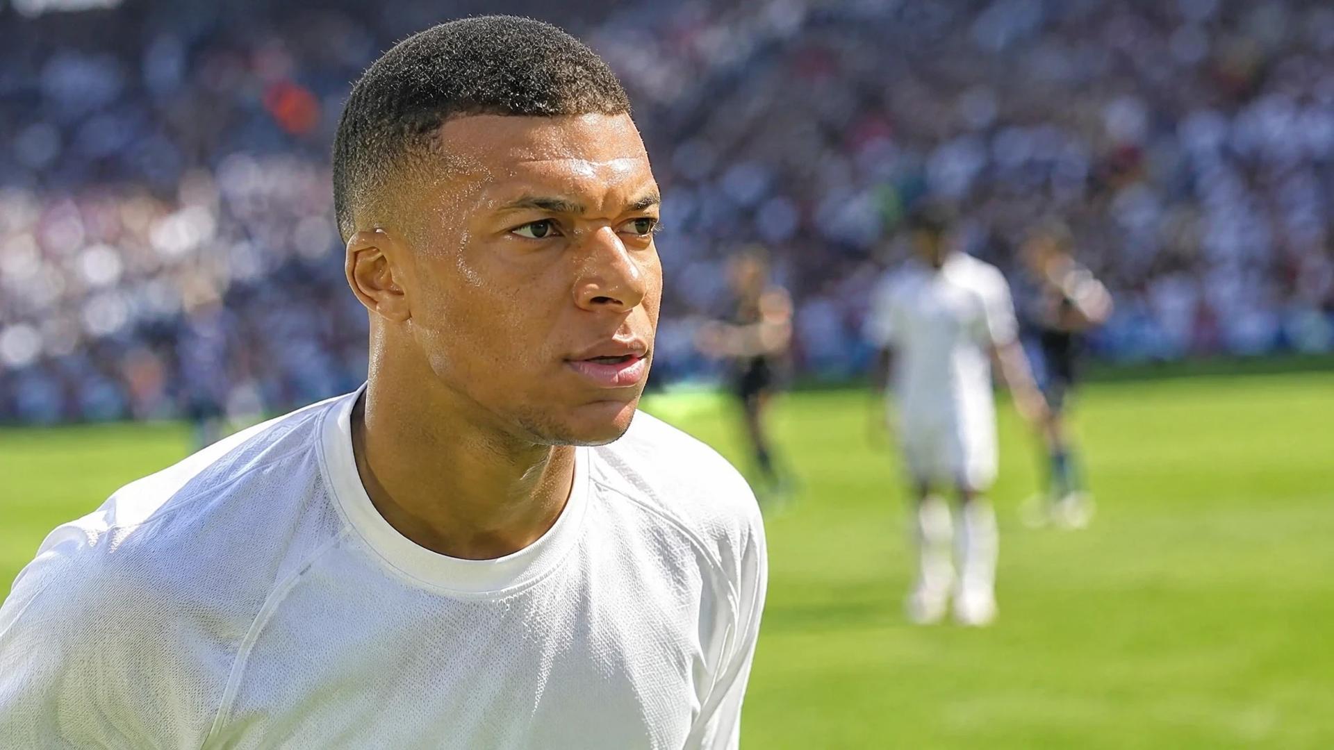 Ethan Mbappé displaying a determined expression during a football match.