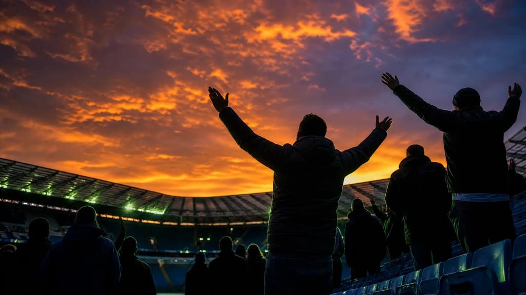 Silhouette of Manchester City fans against a vibrant sunset backdrop.