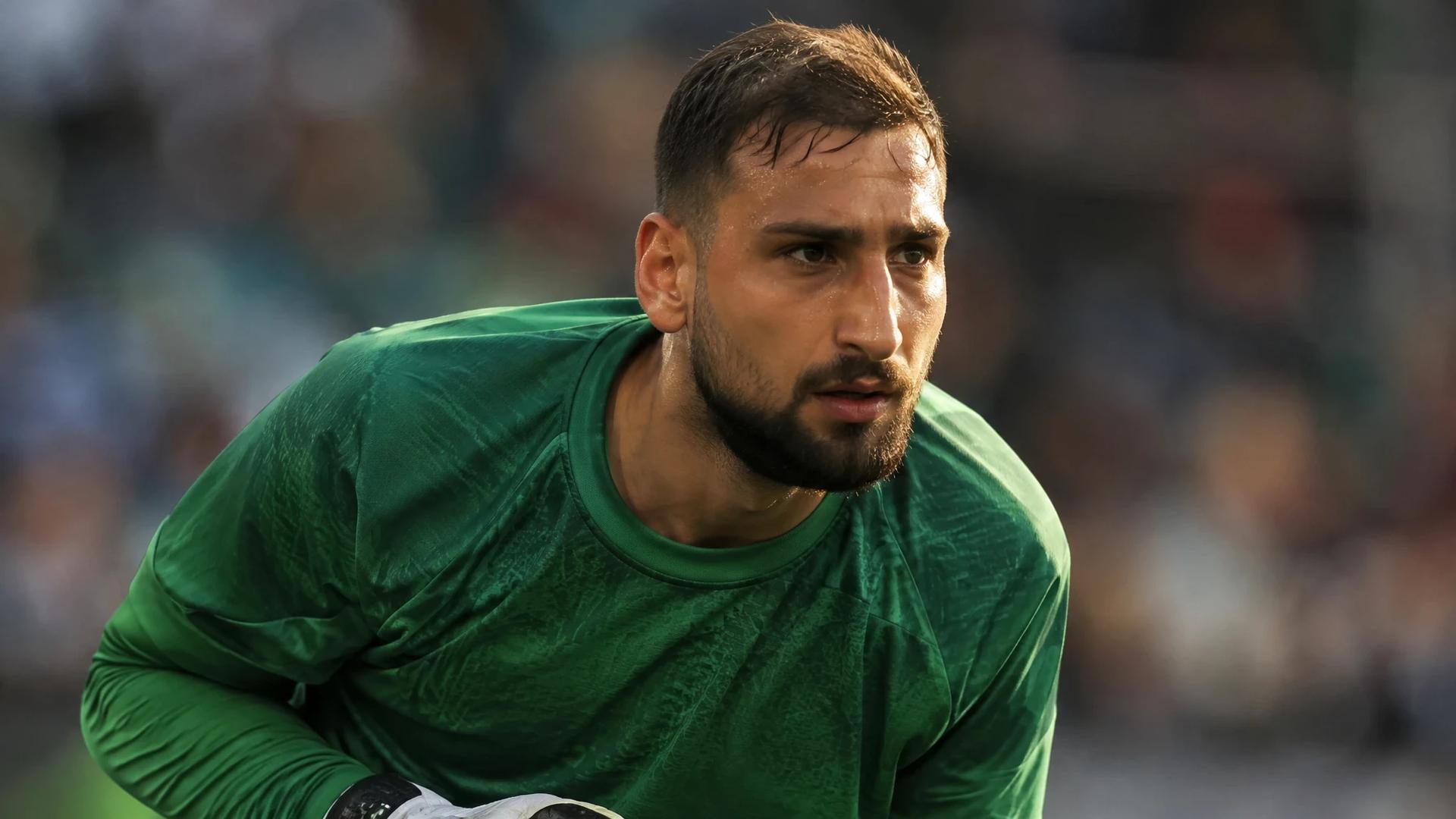 Gianluigi Donnarumma in action during a football match, showcasing his intense focus.