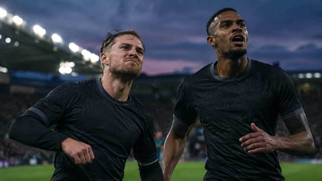 Alexis Mac Allister and Ryan Gravenberch captured during an intense football match, showing strong emotions.