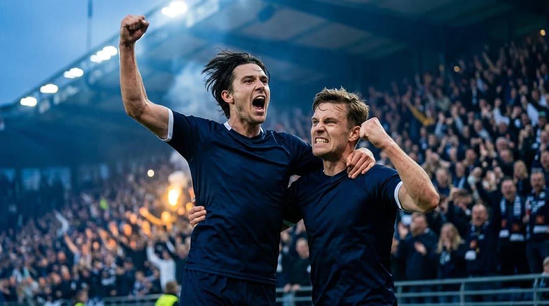 Henrik Heggheim and Peter Christiansen celebrating a goal during a football match.