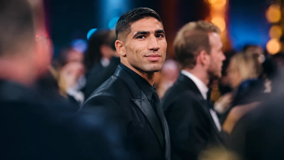 Achraf Hakimi står i fokus blant uklare gjester under en fotballbegivenhet.