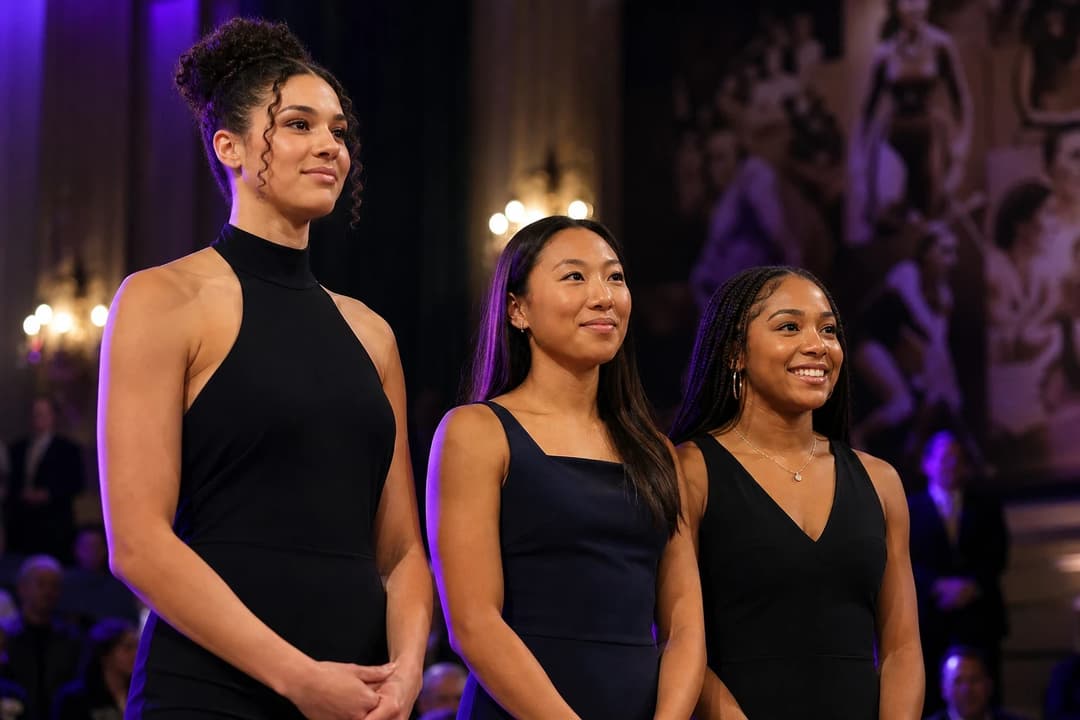Three female athletes poised at a ceremonial awards event celebrating women's sports.