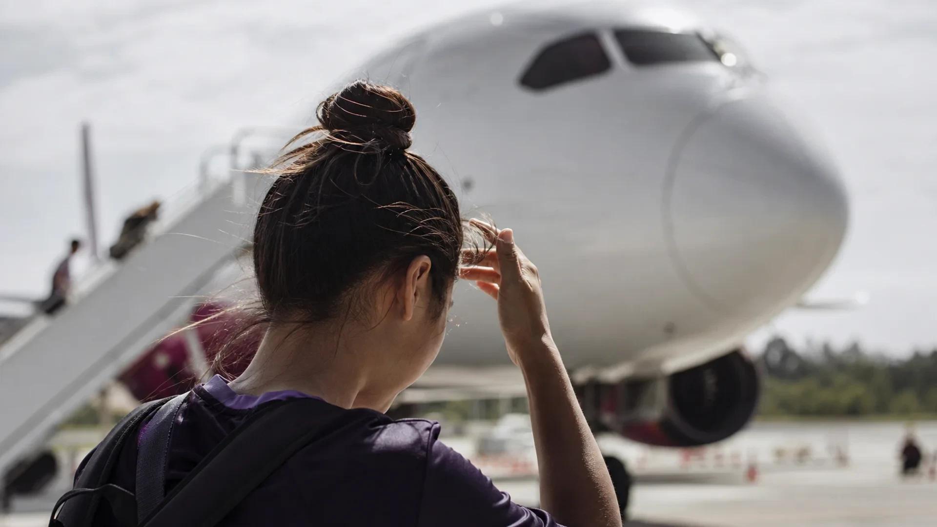 Women’s football player adjusting her hair as the FC Bayern München team arrives at the airport.