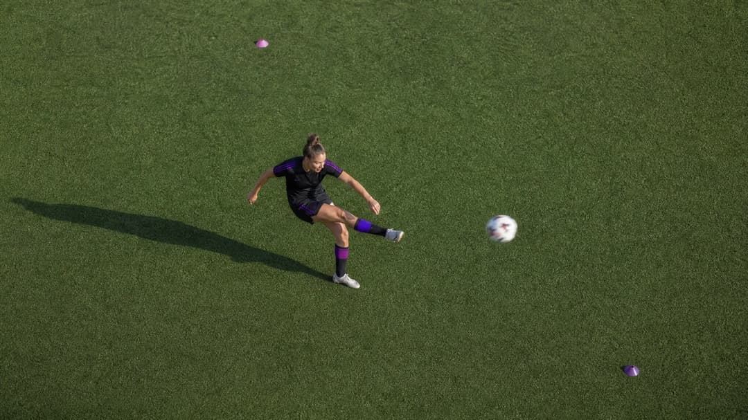 Bird's-eye view of Sarah Brasero kicking a soccer ball during training.