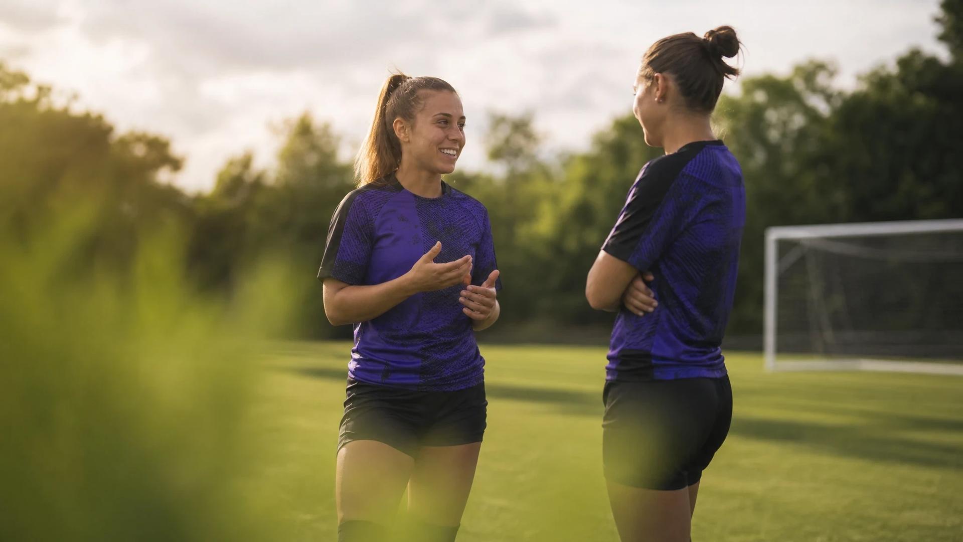 Beatrice Merlo and a teammate engaged in conversation during training.