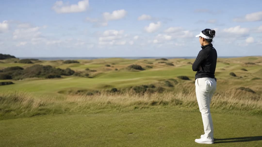 A lone golfer contemplating on the course during a sunny day at Royal Lytham & St Annes.
