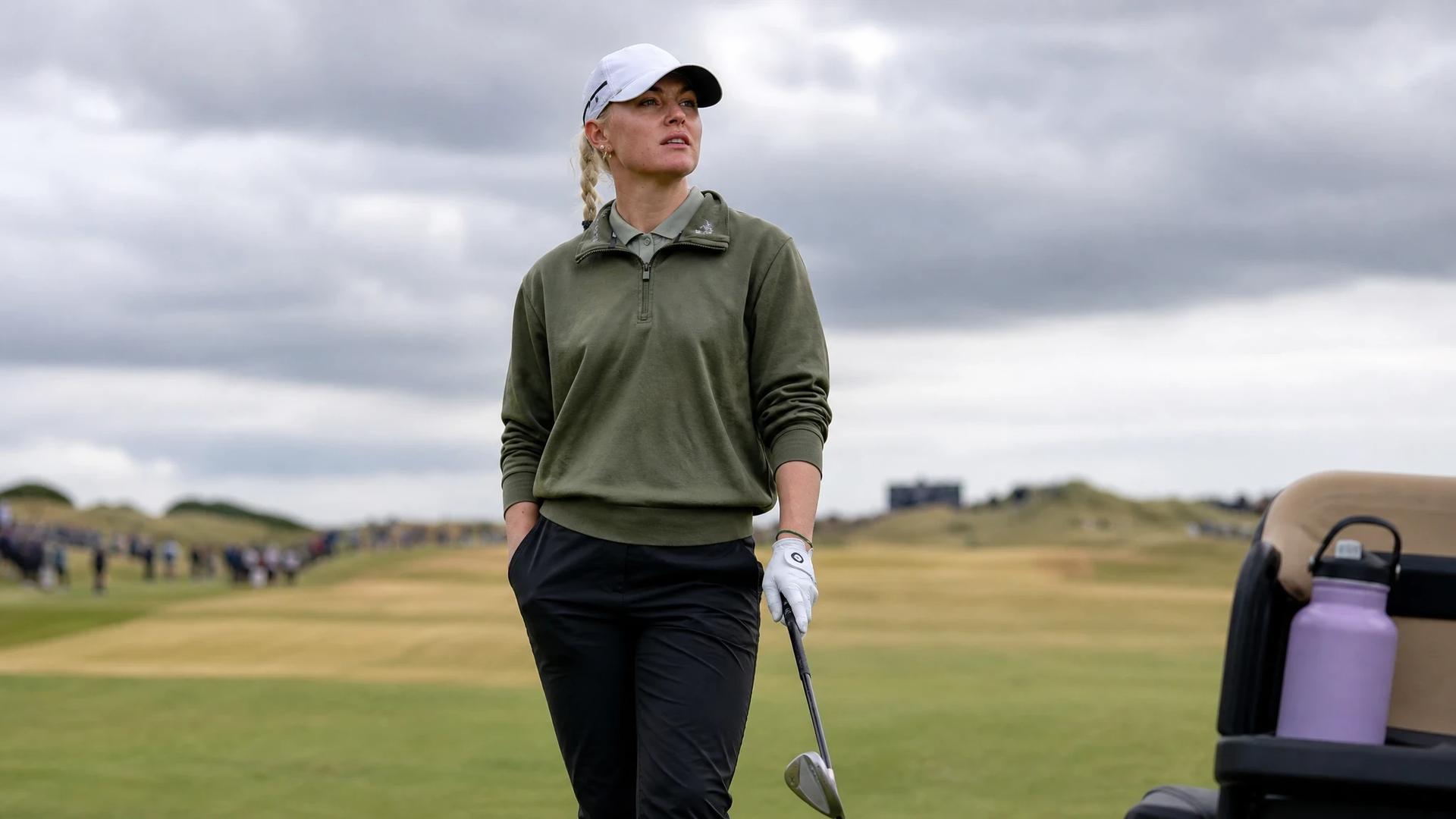 A female golfer stands on the green preparing to take her shot at Royal Lytham & St Annes golf course.