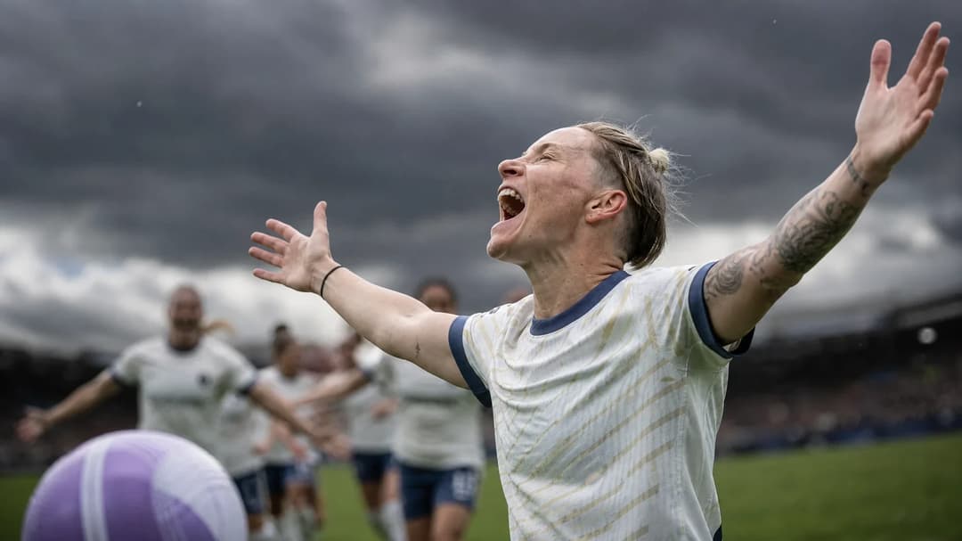Jess Fishlock celebrates after scoring a goal during a football match, with dark storm clouds above.