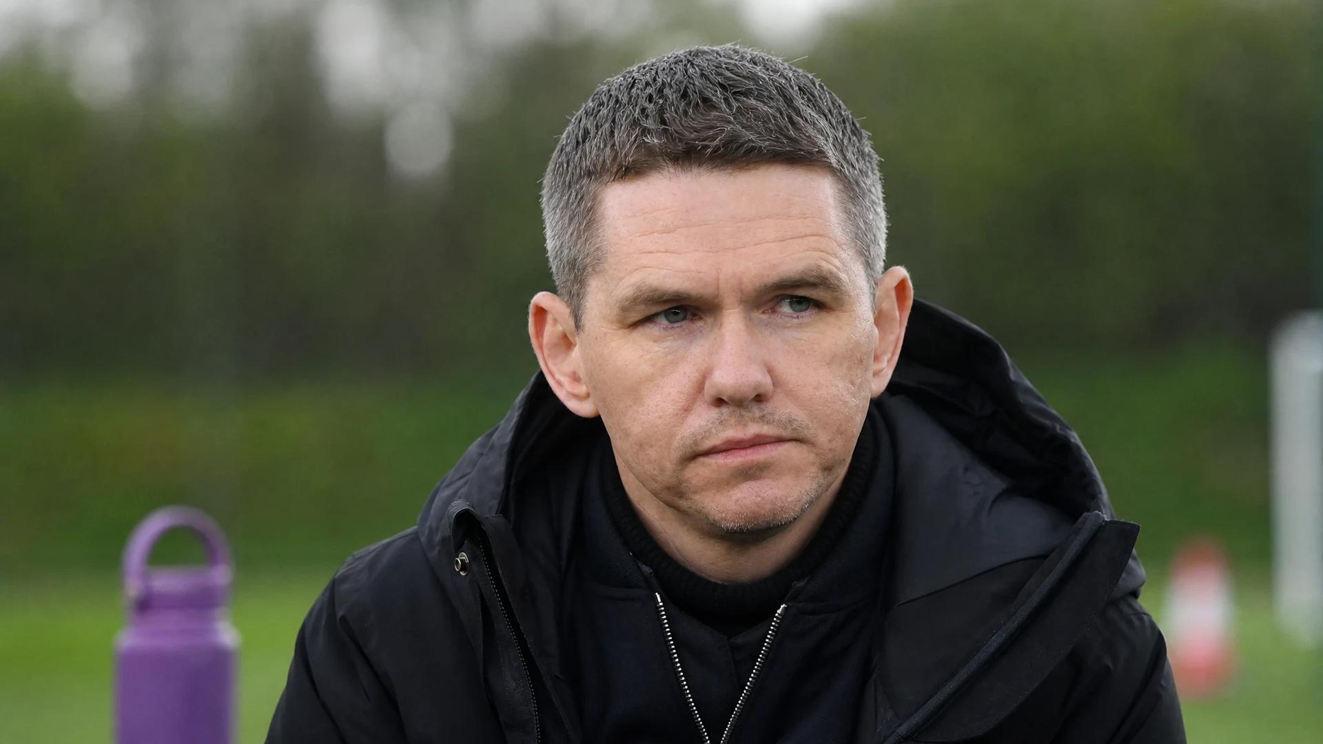 Close-up of Marc Skinner in a reflective moment at Manchester United's training ground.