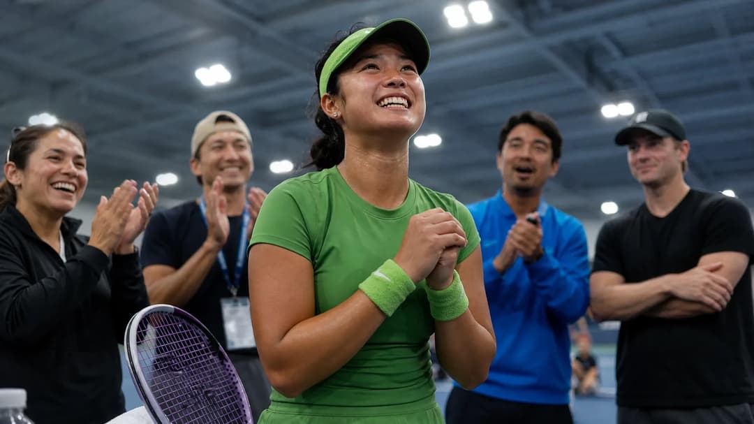 Alex Eala celebrating her victory with supporters in a tennis facility.