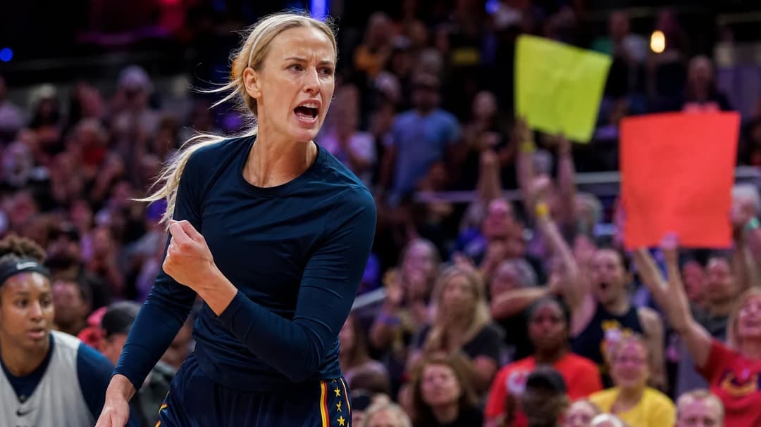 Close-up of Sophie Cunningham during a WNBA game, surrounded by cheering fans holding supportive signs.