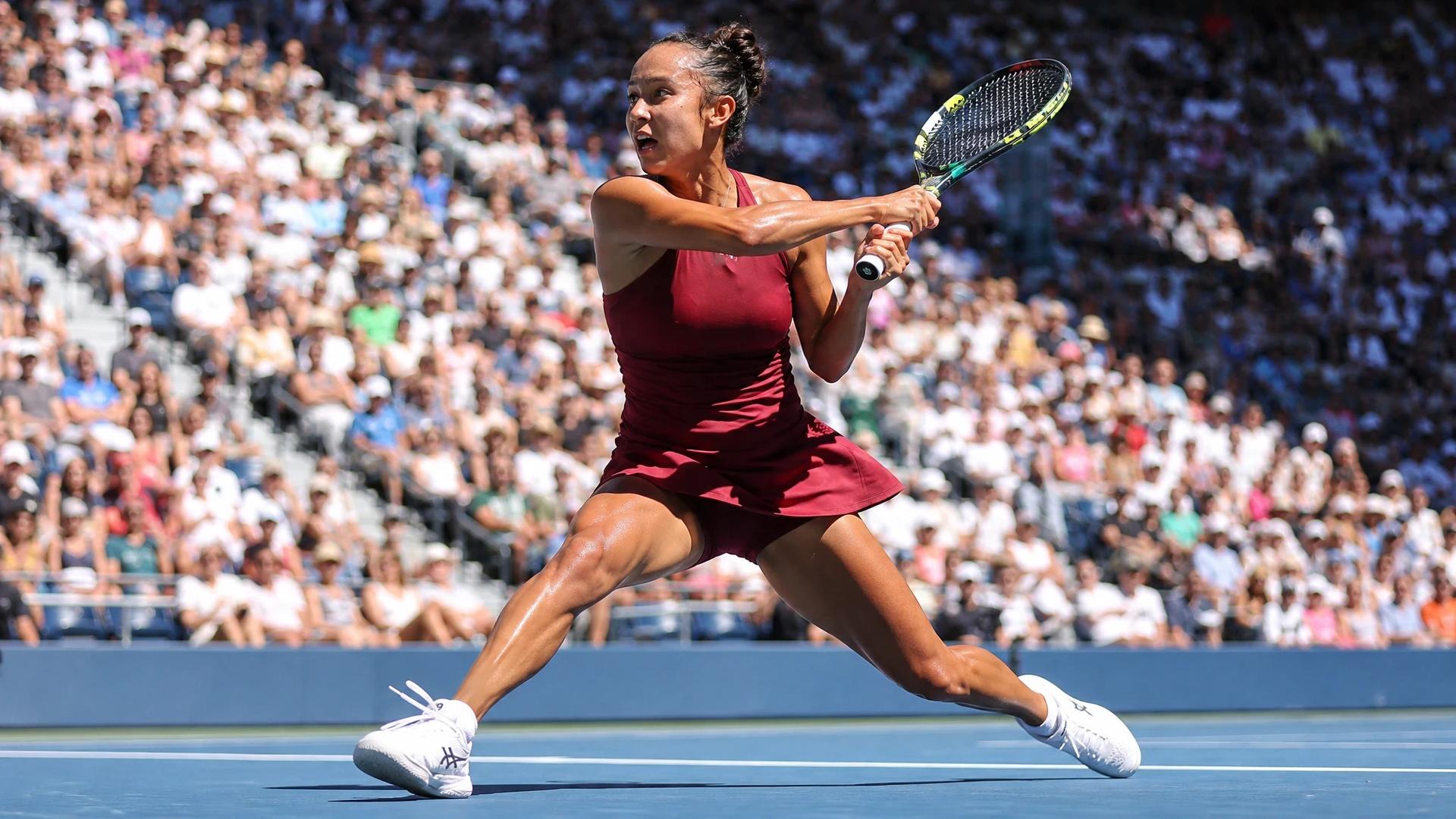 Leylah Fernandez executing a powerful forehand shot on the tennis court during a match.